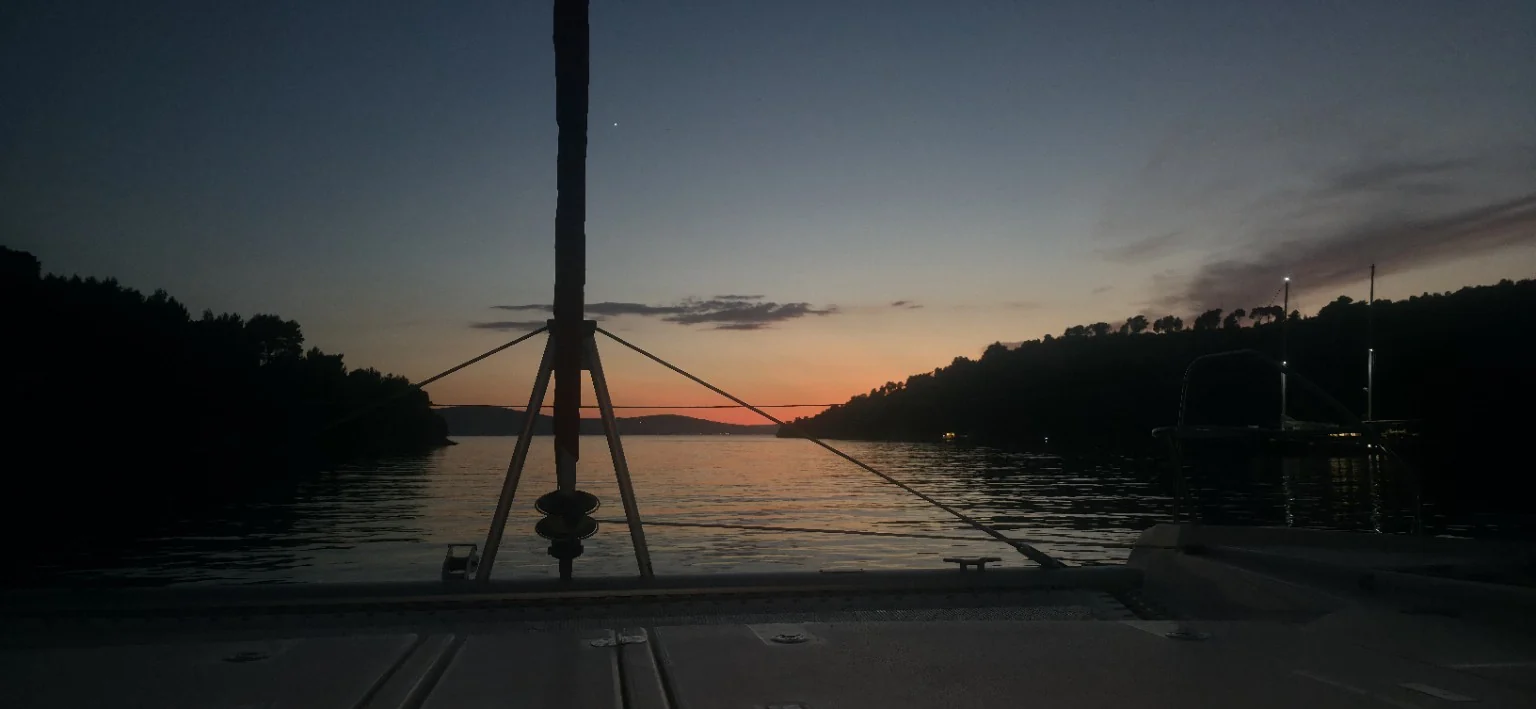 Sunset from the cockpit of a sailing yacht at anchor