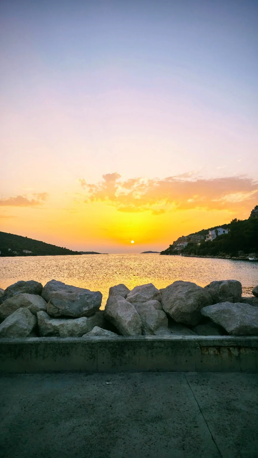 Bright sunset across a sheltered bay from the waterfront